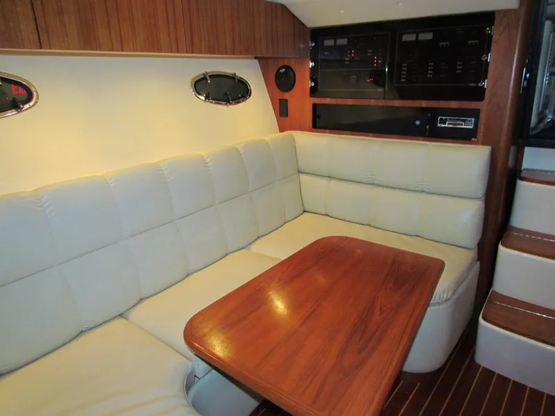 Slide: The Image of 1999 Tiara Yachts 3500 Open interior with plush seating and wooden table. - 45