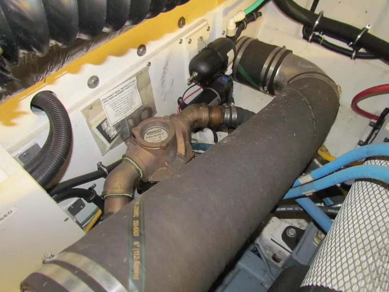 Slide: The Image of Engine compartment of a 1999 Tiara Yachts 3500 Open, showing hoses and mechanical components. - 47