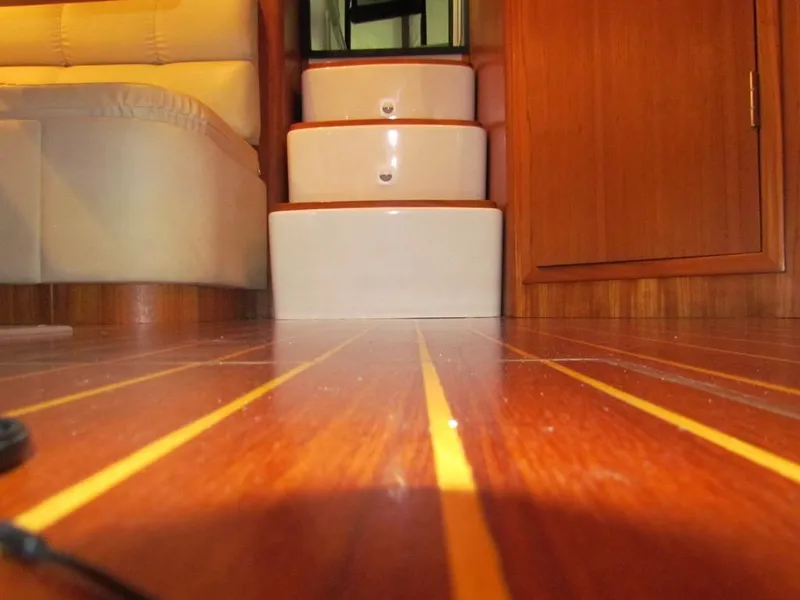 Slide: The Image of Interior of 1999 Tiara Yachts 3500 Open, featuring wooden flooring and steps. - 48