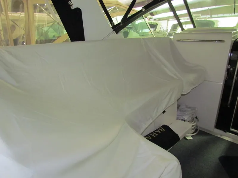 Slide: The Image of 1999 Tiara Yachts 3500 Open interior with covered seating and helm area. - 5