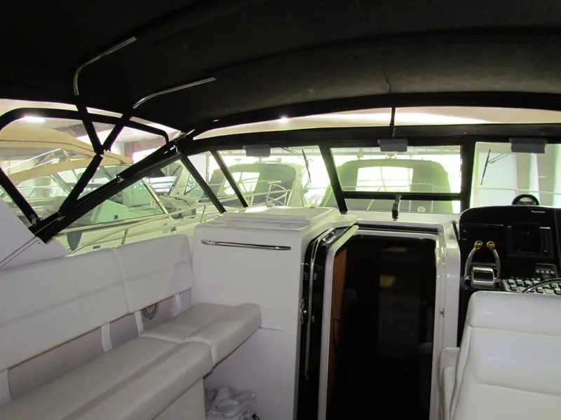 Slide: The Image of Interior view of a 1999 Tiara Yachts 3500 Open, showcasing seating and helm area. - 6
