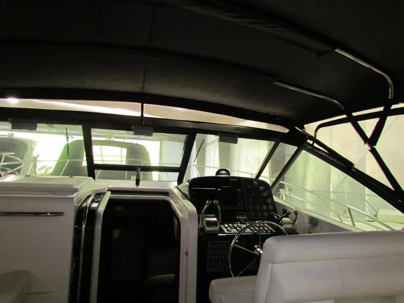 Slide: The Image of 1999 Tiara Yachts 3500 Open cockpit with steering wheel and control panel. - 8