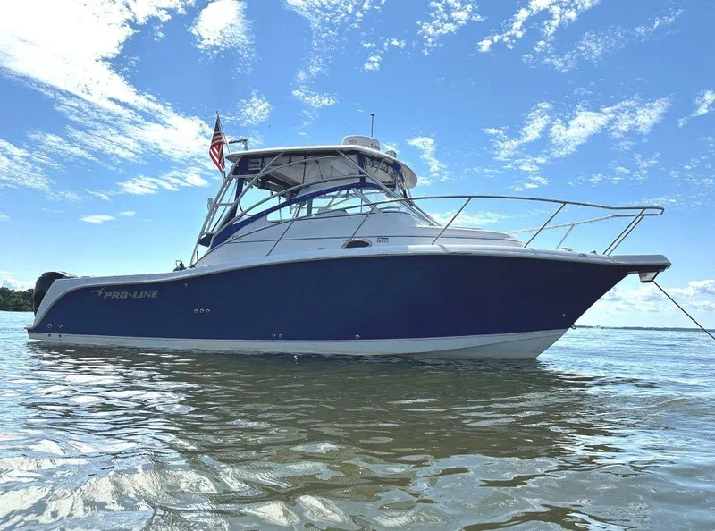 The Image of 2006 Pro-Line 32 Express boat on water under a clear blue sky. - 0