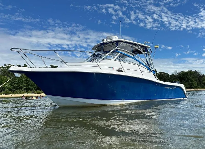 The Image of 2006 Pro-Line 32 Express boat on water under blue sky. - 1