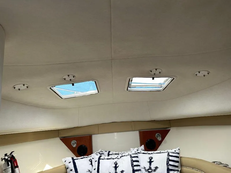Slide: The Image of 2006 Pro-Line 32 Express cabin interior with skylights and nautical-themed pillows. - 10