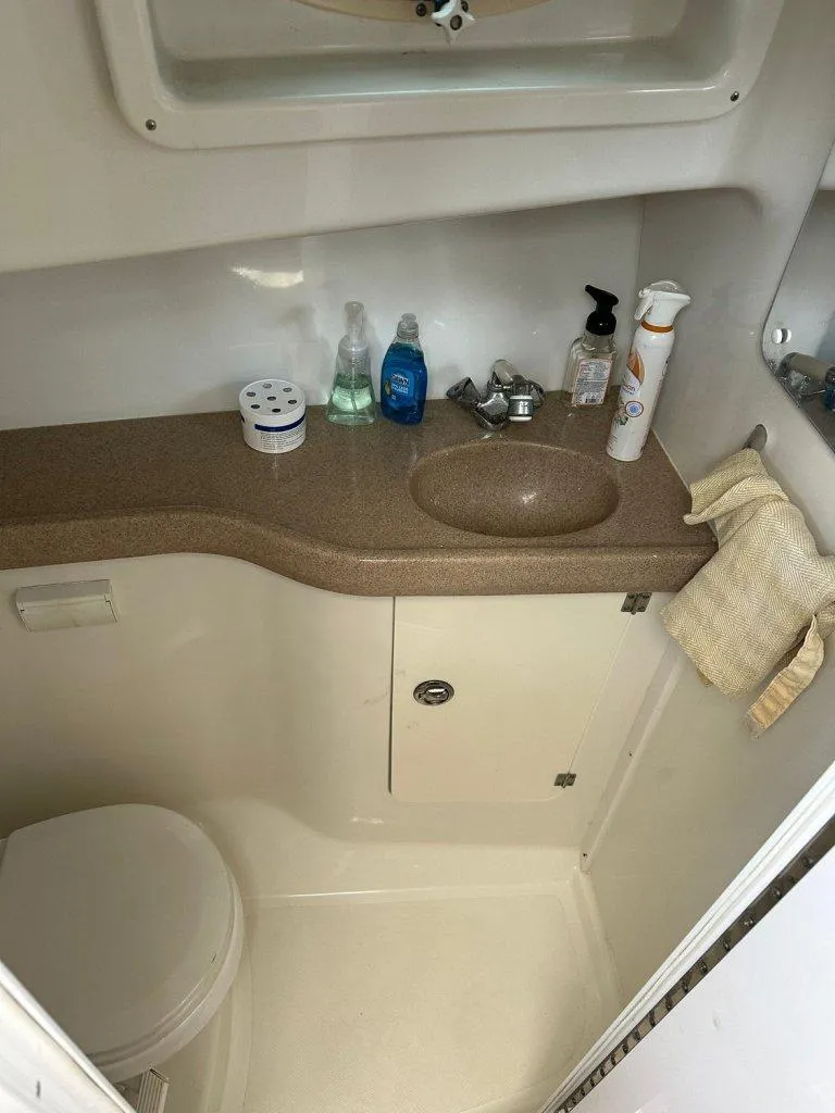 Slide: The Image of 2006 Pro-Line 32 Express boat bathroom with sink, toiletries, and toilet. - 11