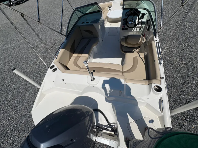 Slide: The Image of 2017 NauticStar 203 DC boat interior with seating and steering, viewed from above. - 10