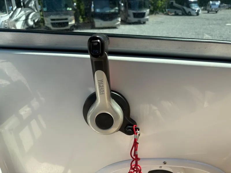 Slide: The Image of Throttle control lever on a 2017 NauticStar 203 DC boat dashboard. - 18