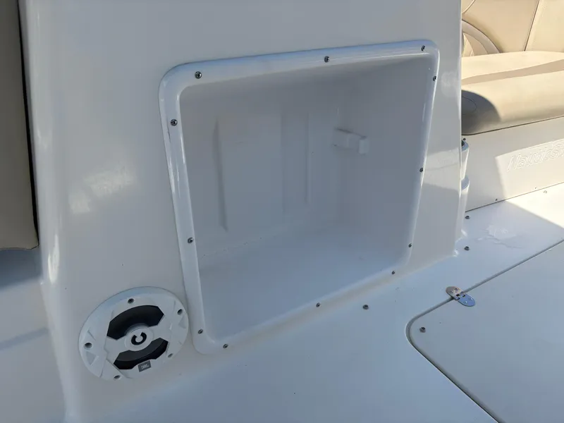 Slide: The Image of 2017 NauticStar 203 DC boat storage compartment and speaker detail. - 19
