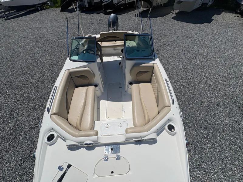 Slide: The Image of 2017 NauticStar 203 DC boat with beige seating, parked on gravel. - 21