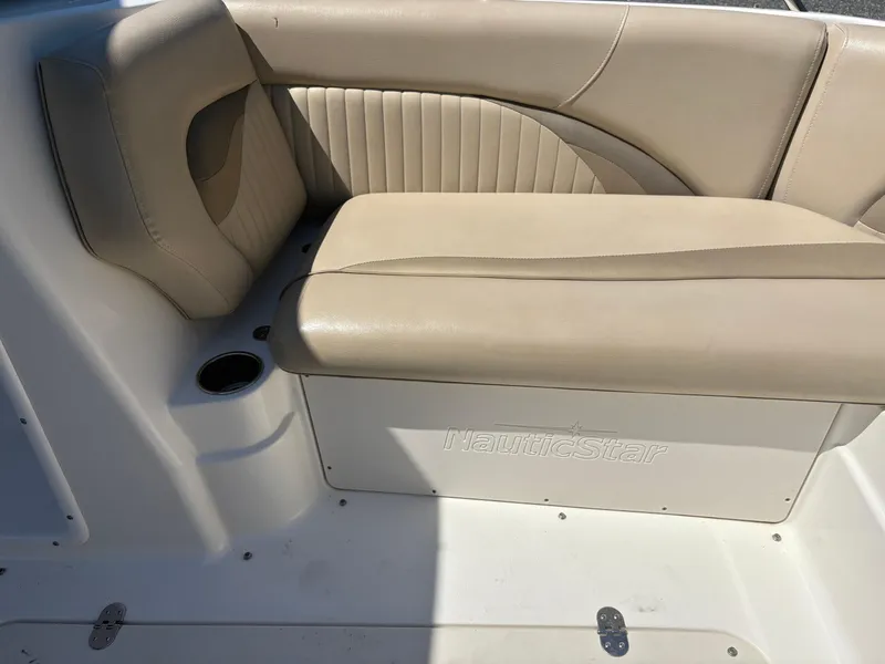 Slide: The Image of 2017 NauticStar 203 DC boat interior with beige seating and cup holder. - 23