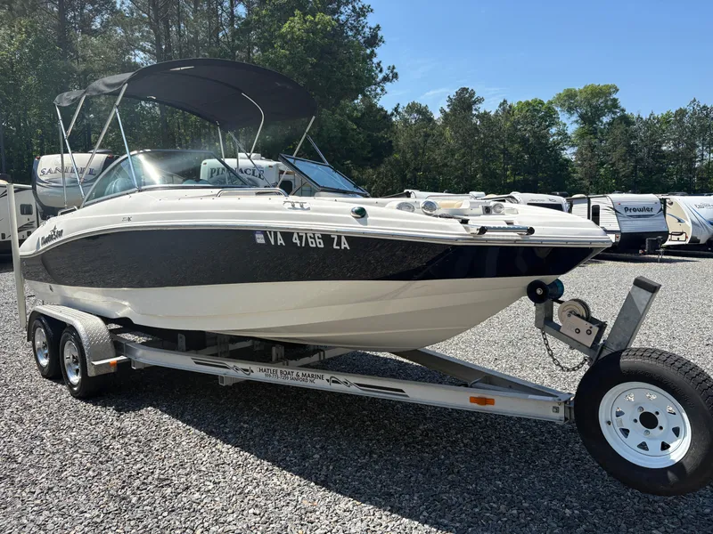 Slide: The Image of 2017 NauticStar 203 DC boat on trailer, parked outdoors on gravel. - 6