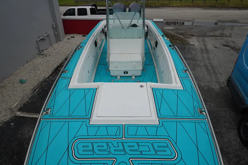 Slide: The Image of 1994 Wellcraft 30 Scarab Sport boat with turquoise deck, viewed from above. - 11