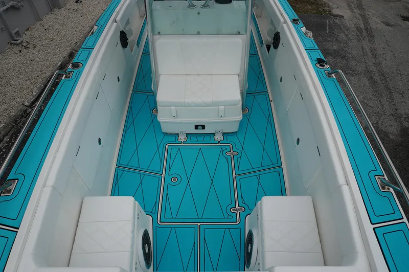 Slide: The Image of 1994 Wellcraft 30 Scarab Sport boat with turquoise deck and white seating. - 12