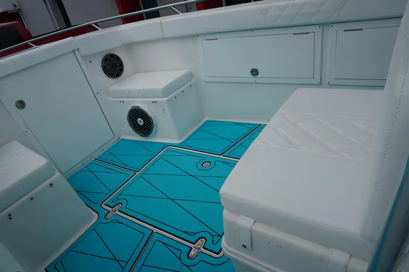 Slide: The Image of 1994 Wellcraft 30 Scarab Sport boat interior with white seating and blue flooring. - 13