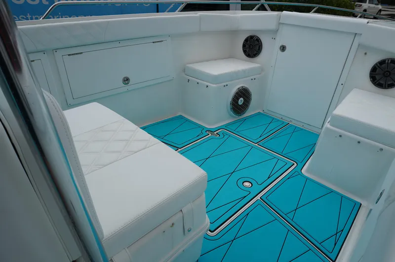 Slide: The Image of 1994 Wellcraft 30 Scarab Sport boat interior with turquoise flooring and white seating. - 14