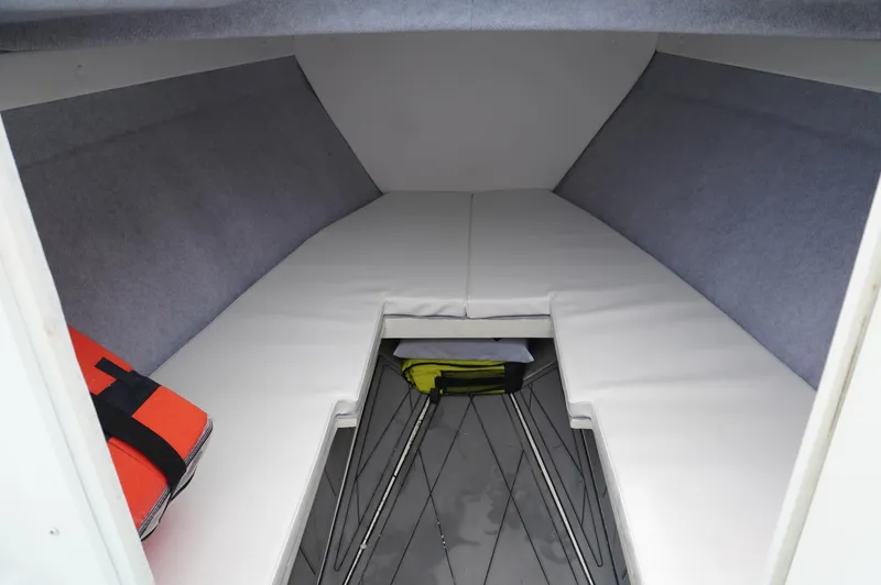 Slide: The Image of 1994 Wellcraft 30 Scarab Sport cabin interior with cushions and life jacket. - 16