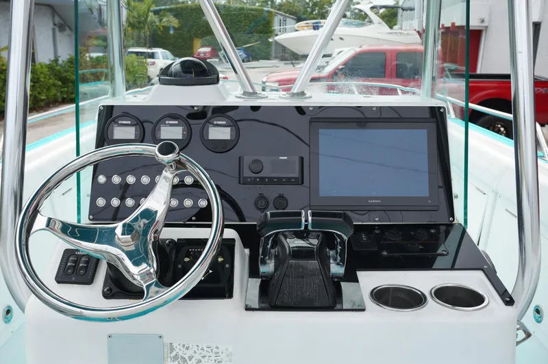 Slide: The Image of 1994 Wellcraft 30 Scarab Sport boat dashboard with steering wheel and modern controls. - 19