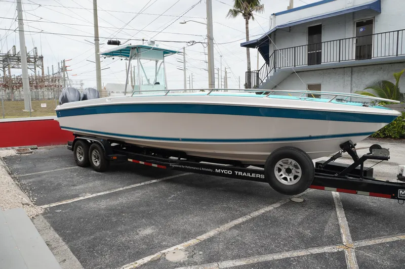 Slide: The Image of 1994 Wellcraft 30 Scarab Sport boat on trailer in parking lot. - 5