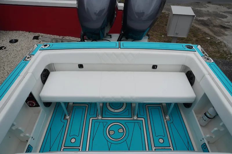 Slide: The Image of 1994 Wellcraft 30 Scarab Sport boat interior with turquoise flooring and white seating. - 6