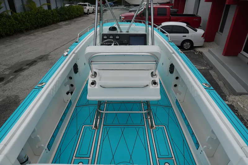 Slide: The Image of 1994 Wellcraft 30 Scarab Sport boat interior with turquoise flooring and white seating. - 7