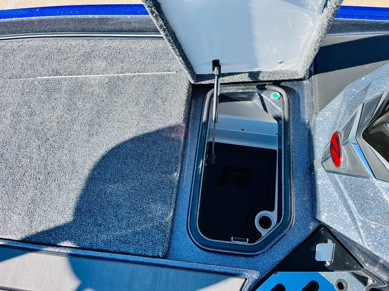 Slide: The Image of 2025 Ranger Z520R Cup-Equipped boat storage compartment with open lid, showcasing interior design. - 21