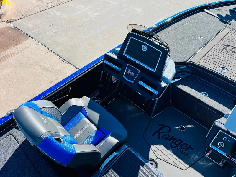 Slide: The Image of 2025 Ranger Z520R Cup-Equipped boat interior with blue and black seating and dashboard. - 28