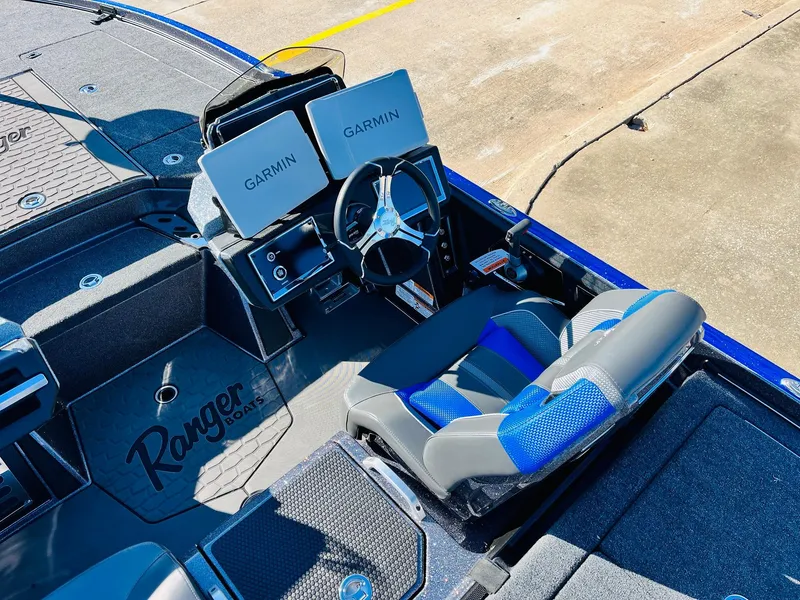 Slide: The Image of 2025 Ranger Z520R Cup-Equipped boat interior with Garmin displays and blue-accented seating. - 32