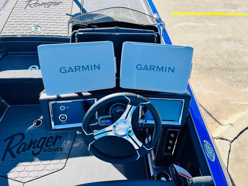 Slide: The Image of 2025 Ranger Z520R Cup-Equipped boat dashboard with dual Garmin displays and steering wheel. - 33