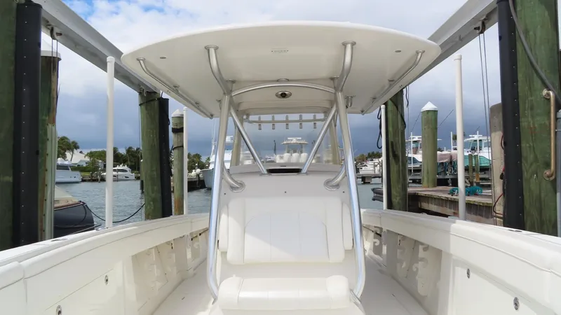 Slide: The Image of 2013 Jupiter 34 boat docked, featuring spacious deck and sleek design. - 11
