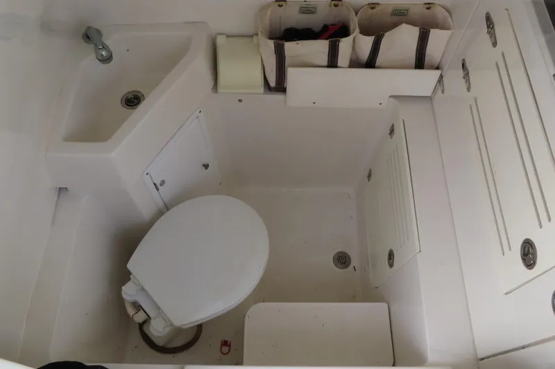 Slide: The Image of Compact bathroom in a 2013 Jupiter 34 boat with toilet and sink. - 15
