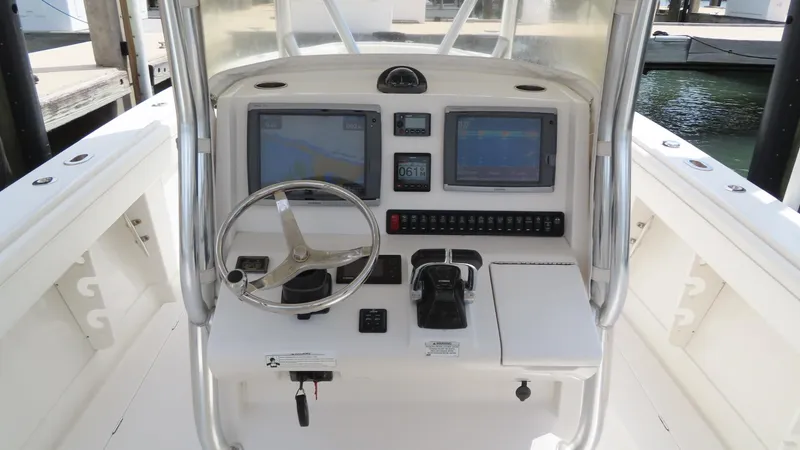 Slide: The Image of 2013 Jupiter 34 boat console with dual screens and steering wheel. - 16