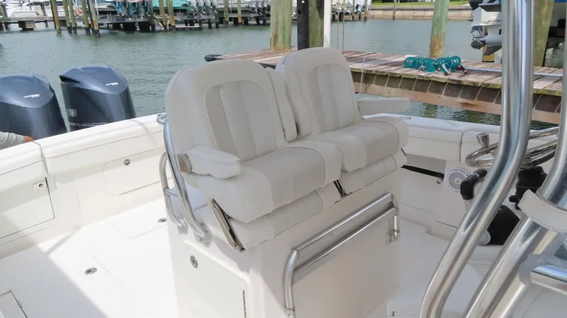 Slide: The Image of 2013 Jupiter 34 boat interior with dual white seats and stainless steel accents. - 18