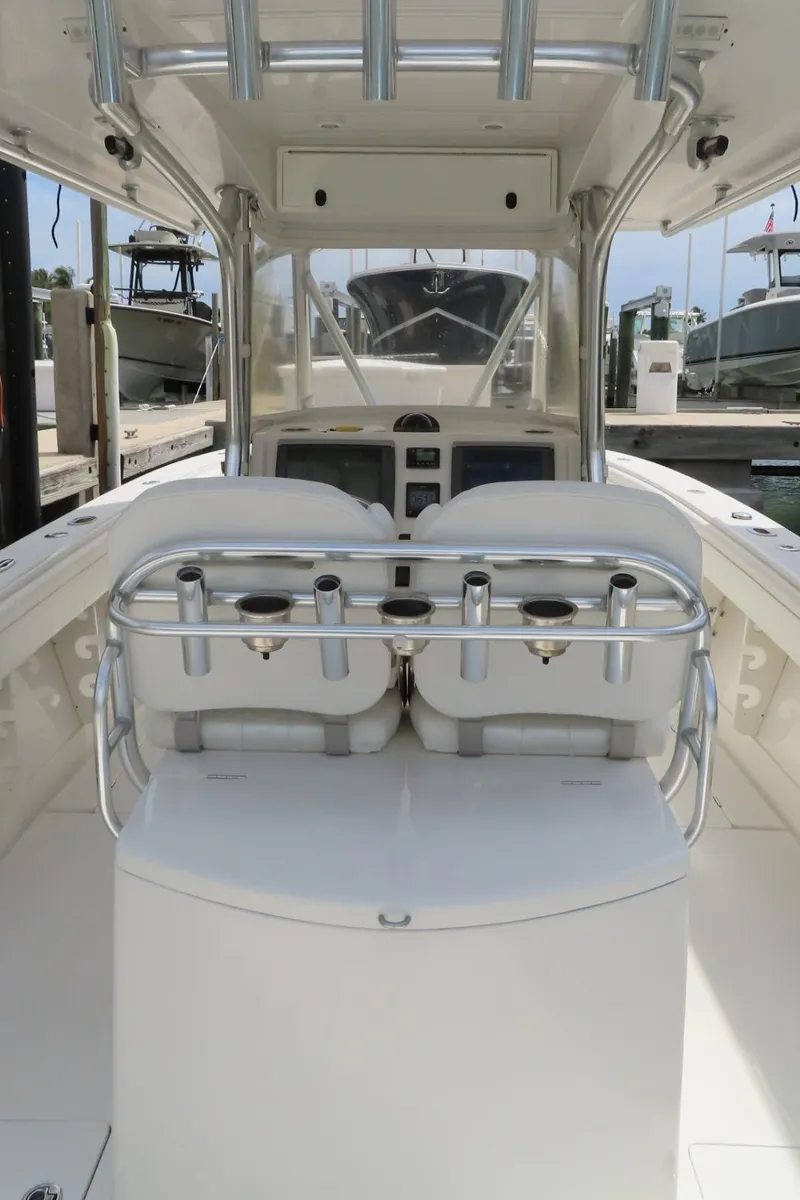Slide: The Image of 2013 Jupiter 34 boat interior with helm, seating, and rod holders. - 19