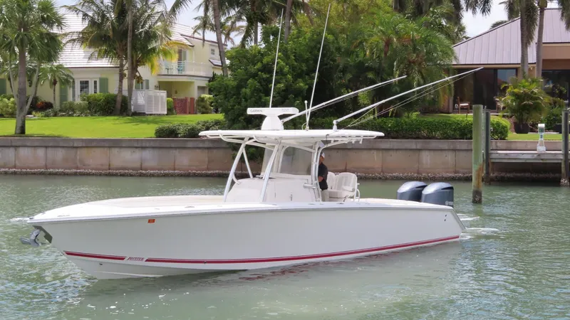Slide: The Image of 2013 Jupiter 34 boat docked in a scenic waterfront setting. - 2