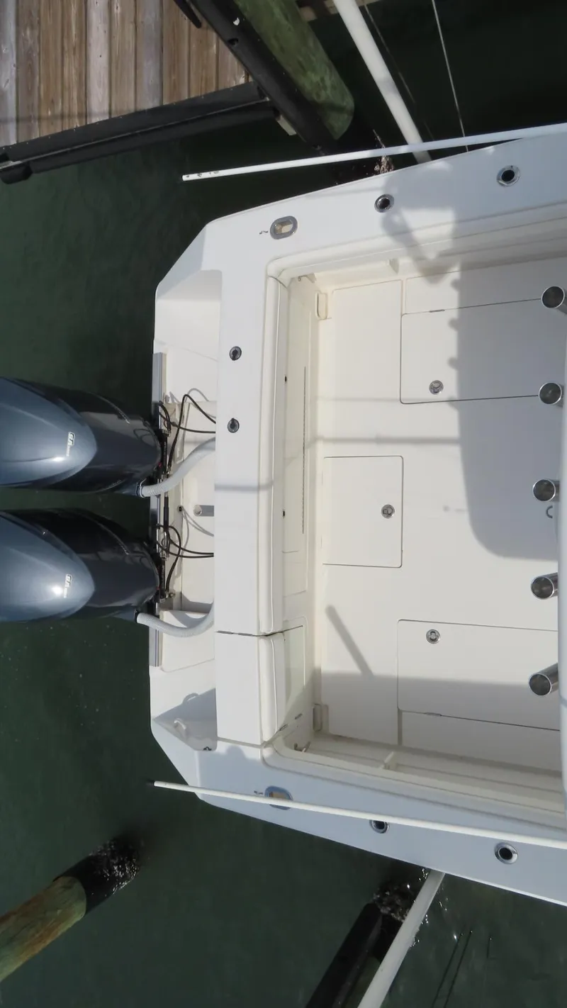 Slide: The Image of Overhead view of a 2013 Jupiter 34 boat's stern with dual outboard motors. - 22
