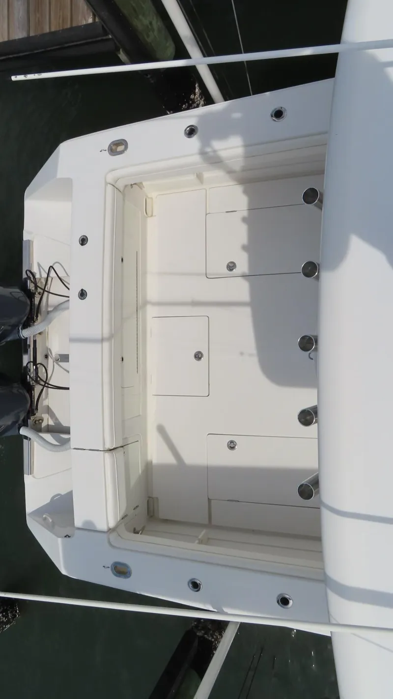 Slide: The Image of 2013 Jupiter 34 boat deck with storage compartments and clean white finish. - 23