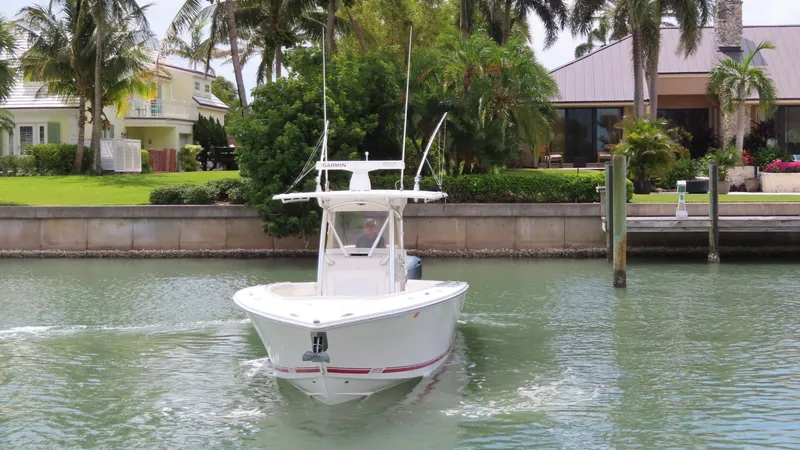 Slide: The Image of 2013 Jupiter 34 boat cruising near waterfront homes with palm trees. - 3