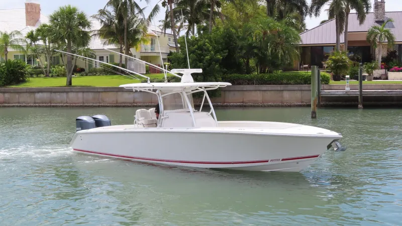 Slide: The Image of 2013 Jupiter 34 boat cruising on a calm waterway near waterfront homes. - 4