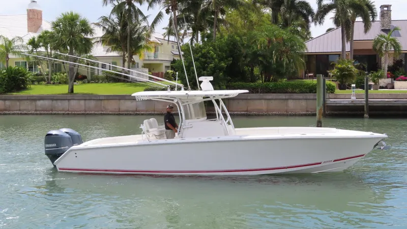 Slide: The Image of 2013 Jupiter 34 boat cruising on a calm waterway near waterfront homes. - 5