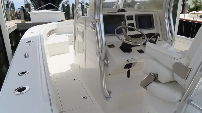 Slide: The Image of 2013 Jupiter 34 boat interior with steering wheel and navigation screens. - 6