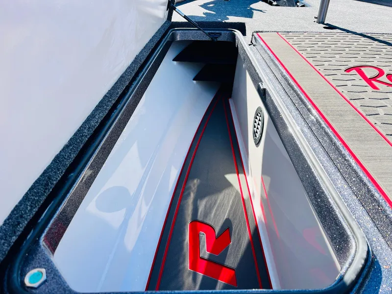 Slide: The Image of 2025 Ranger Z520R Cup-Equipped boat storage compartment with sleek design and red accents. - 16