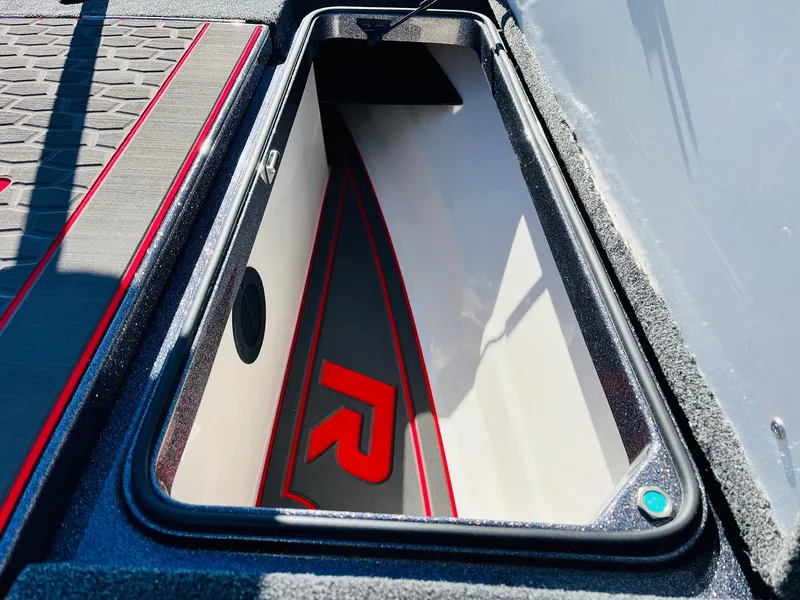 Slide: The Image of 2025 Ranger Z520R Cup-Equipped boat storage compartment with sleek design and red accents. - 22