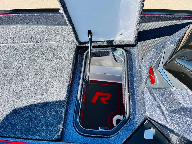 Slide: The Image of 2025 Ranger Z520R Cup-Equipped boat storage compartment with open lid and logo. - 24