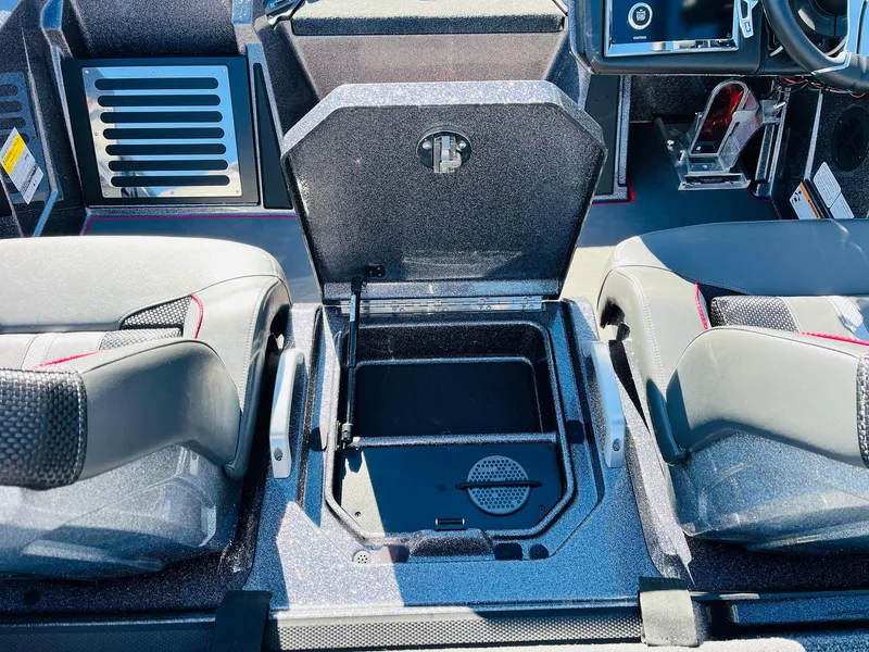 Slide: The Image of 2025 Ranger Z520R Cup-Equipped boat interior with open storage compartment between seats. - 34