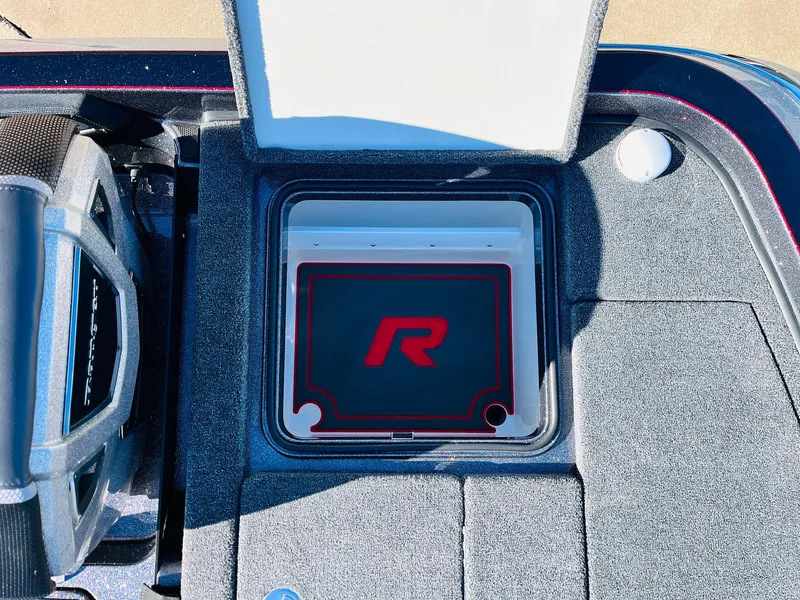 Slide: The Image of 2025 Ranger Z520R Cup-Equipped boat storage compartment with open lid and logo. - 46