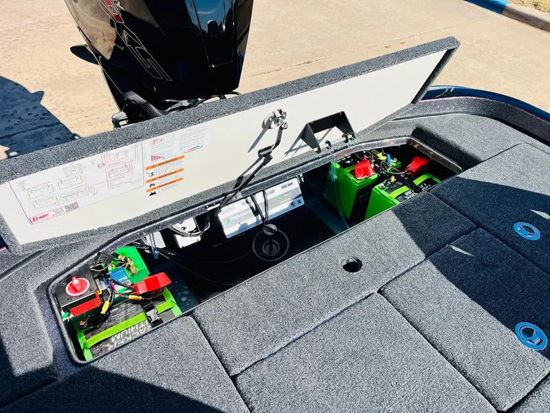 Slide: The Image of 2025 Ranger Z520R Cup-Equipped boat battery compartment with open hatch, showing wiring and components. - 47