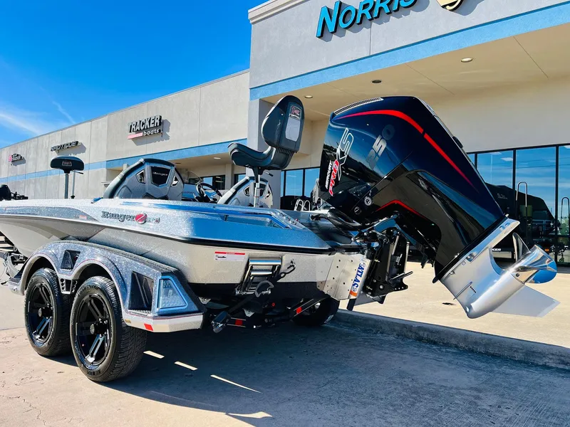Slide: The Image of 2025 Ranger Z520R Cup-Equipped boat with powerful outboard motor, parked outside dealership. - 7