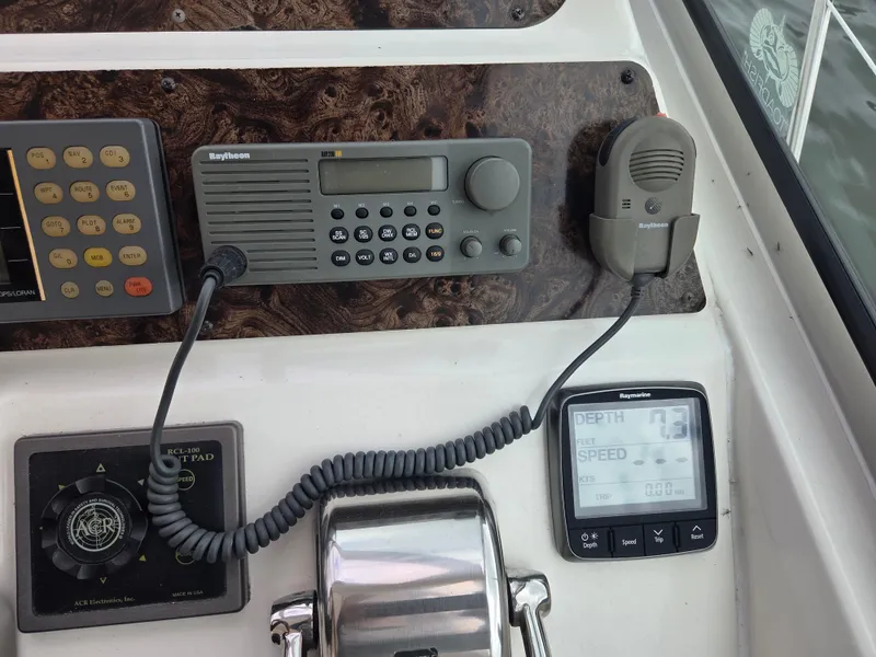 Slide: The Image of Control panel of a 1998 Sea Ray 400 Sundancer with radio and depth gauge. - 12