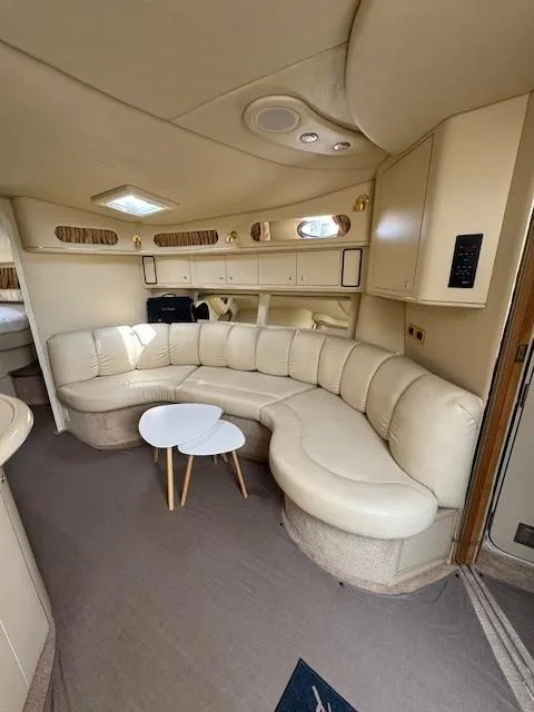 Slide: The Image of Luxurious interior of a 1998 Sea Ray 400 Sundancer yacht with curved seating and modern decor. - 13